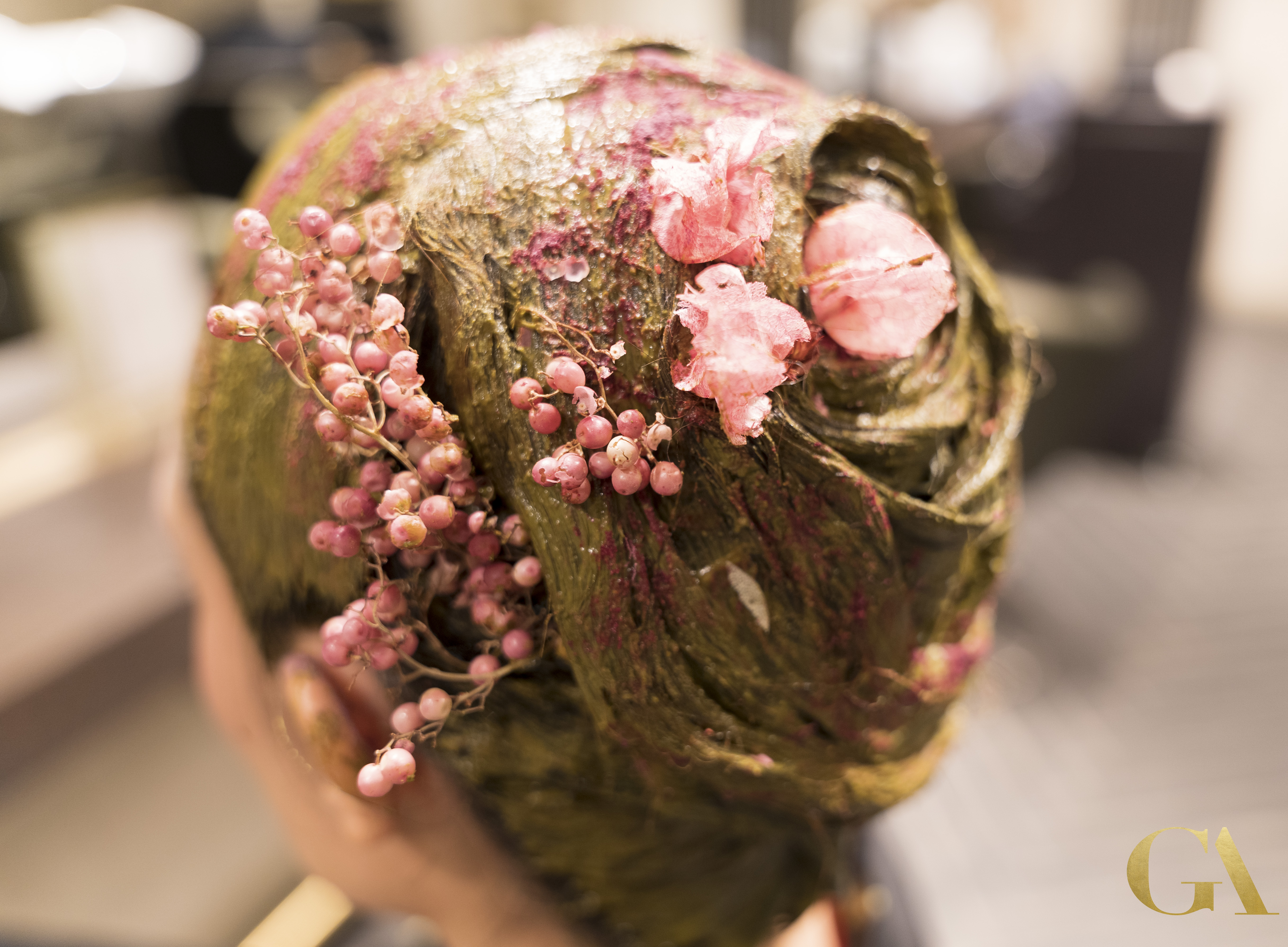 Natural herbal hair treatment with colorful pigments and flowers at GA Salons