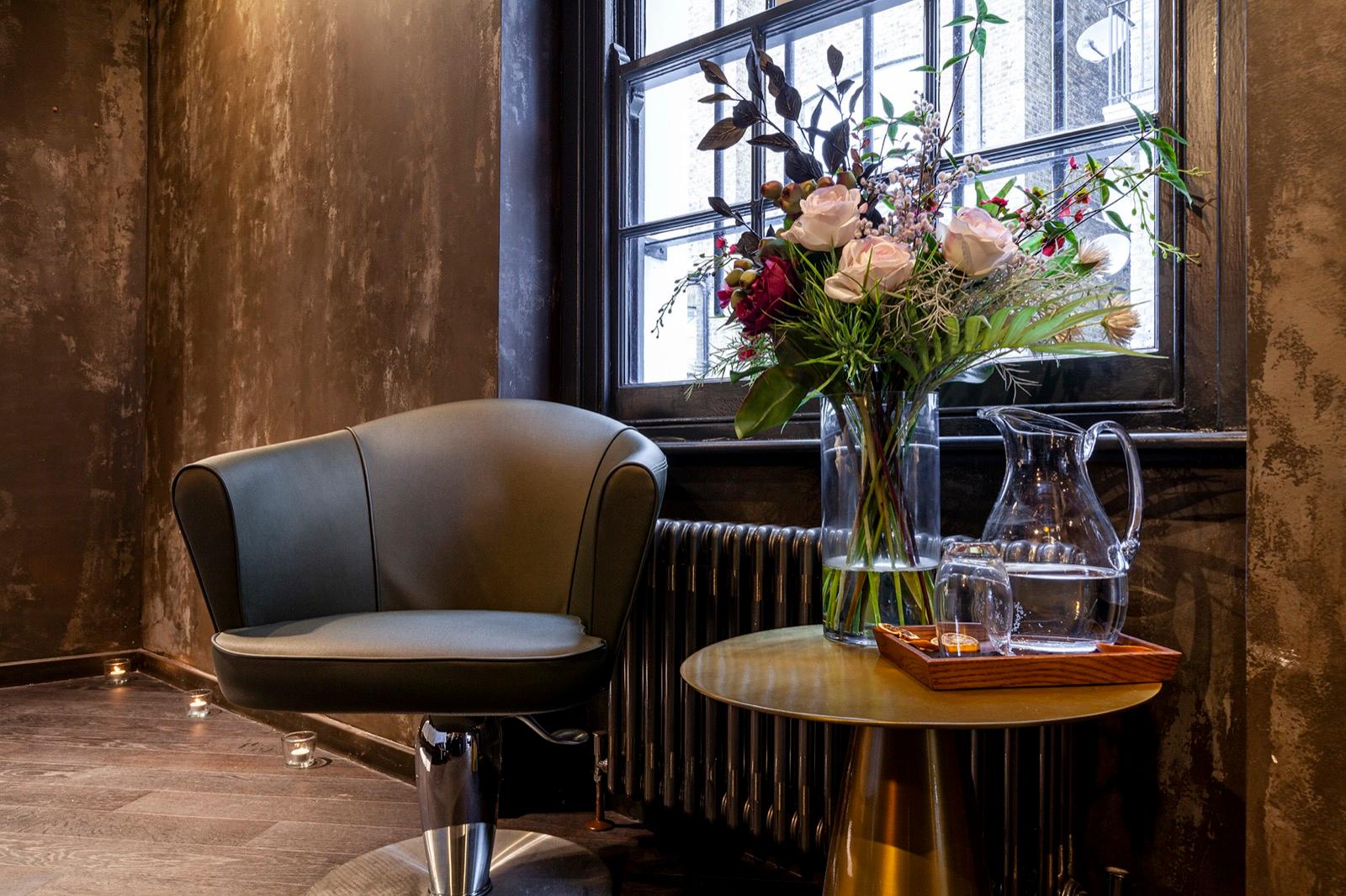 Elegant waiting area with fresh floral arrangements at luxury Chelsea salon