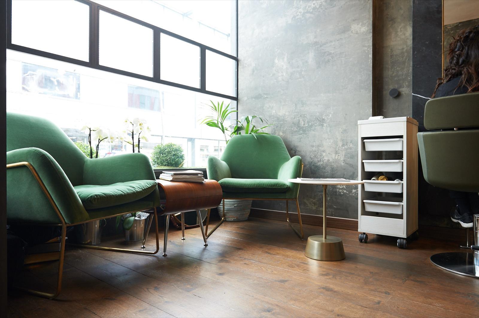 The sitting corner at GA — velvet armchairs, brass, orchids and morning light